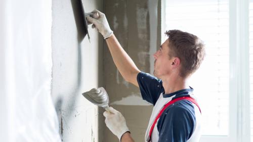 Man plastering the wall